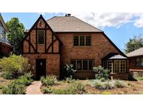 Charming Tudor home with brick facade, leaded glass window, and well-maintained landscaping at 911 Lincoln Pl, Boulder, CO 80302