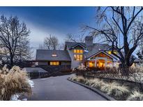 Elegant home with a sprawling driveway and mature landscaping, offering a private and serene setting at 6483 S Prince St, Littleton, CO 80120