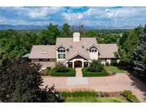 Stunning home with lush landscaping, a neutral palette and mountain views from the front lawn at 6483 S Prince St, Littleton, CO 80120