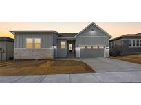 Charming home showcasing a modern design, three car garage, and clean landscaping at 7301 Canyon Sky Trl, Castle Pines, CO 80108