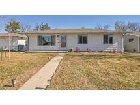 Charming ranch home with well-manicured lawn and walkway at 1600 S Dahlia St, Denver, CO 80222