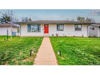 Charming home with a well-manicured lawn and a welcoming red door at 1600 S Dahlia St, Denver, CO 80222