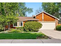 Charming single-Gathering home featuring a manicured lawn, mature trees, and a two-car garage, perfect for suburban living at 7548 S Crocker Ct, Littleton, CO 80120