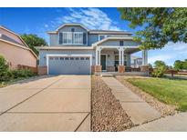 Charming two-story home with a covered front porch, large driveway and beautiful landscaping at 10301 E 112Th Way, Commerce City, CO 80640