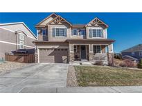 Charming two-story home boasts a manicured lawn, a welcoming front porch, and a two-car garage at 2896 Setting Sun Ave, Castle Rock, CO 80109