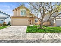 Charming two-story home featuring a well-manicured lawn and a two-car garage at 12552 Tammywood St, Broomfield, CO 80020
