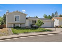 Charming two-story home with a well-manicured lawn, inviting curb appeal and a two car garage at 1043 Lilac Ct, Broomfield, CO 80020