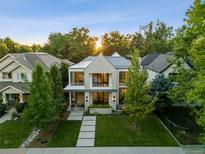 Stunning two-story home with modern architecture, lush landscaping, and a welcoming walkway at 2475 S Saint Paul St, Denver, CO 80210