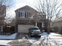 Charming two-story home with stone accents, attached garage, and well-maintained landscaping in a residential neighborhood at 7456 E 10Th Ave, Denver, CO 80230