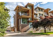 Modern townhome showcasing wood and brick accents, balconies, and professional landscaping at 2758 W 22Nd Ave, Denver, CO 80211