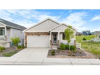 Charming single-Gathering home with stone accents, well-maintained landscaping, and an attached two-car garage at 2060 Peralta Loop, Castle Rock, CO 80104