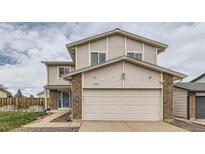 Charming two-story home features a two-car garage, brick accents, and neutral siding at 18843 E Colorado Dr, Aurora, CO 80017