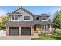 Charming two-story home showcasing a well-manicured lawn, brick accents, and an attached two-car garage at 3055 E 133Rd Cir, Thornton, CO 80241