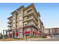 Beautiful condominium building featuring brick and tan siding, multiple stories, and private balconies at 10111 Inverness Main St # 228, Englewood, CO 80112