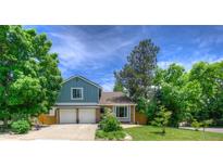 Charming two-story home with a well-manicured lawn and a two-car garage at 8140 S Storm King Peak, Littleton, CO 80127