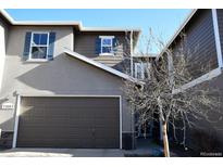Charming home exterior with a two-car garage and decorative blue shutters at 11883 E Fair Ave, Greenwood Village, CO 80111