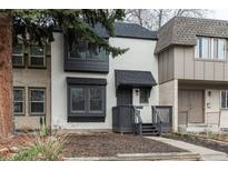 Charming two-story townhome featuring a combination of white painted brick and muted siding and a front porch at 11645 Lincoln St, Northglenn, CO 80233