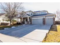 Charming two-story home with three-car garage and landscaped front yard at 12490 Kearney Cir, Thornton, CO 80602
