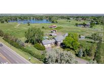 Sprawling estate with a charming home, a refreshing pool, and a serene lake backdrop at 14447 Madison St, Thornton, CO 80602