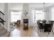 Bright living room featuring a modern fireplace, wood floors, and neutral decor, creating a cozy and inviting space at 4500 E Louisiana Ave, Denver, CO 80246