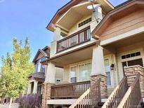 Charming townhome with two-story entrance, stone accents, and a cozy balcony at 1368 Royal Troon Dr, Castle Rock, CO 80104