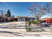 Charming single-story home with a covered carport and a well-maintained front yard at 715 Zang St, Lakewood, CO 80401