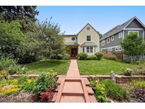 Charming two-story home with landscaped yard and inviting walkway at 2432 S Columbine St, Denver, CO 80210