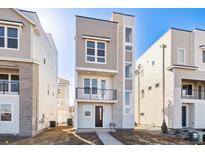 Modern two-story home with gray and white siding, black accents and a small front-facing balcony at 1267 Rhett Dr, Erie, CO 80026