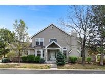 Charming two-story home with a well-manicured lawn and mature trees at 2032 W Nantucket Ct, Littleton, CO 80120