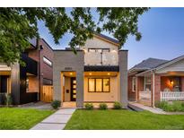 Charming two-story home boasting modern architecture and a well-manicured front yard at 2060 Eliot St, Denver, CO 80211