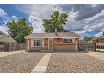 Charming brick home with a well-kept front yard and a cozy, welcoming entrance at 6991 Warren Dr, Denver, CO 80221