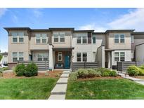 Inviting townhome with a manicured lawn and charming front porch, creating curb appeal at 4774 Kittredge St, Denver, CO 80239
