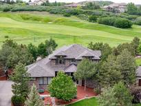 Beautiful home featuring a well-maintained lawn, mature trees, and stunning golf course views at 4586 Carefree Trl, Parker, CO 80134