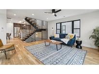 Bright living room with hardwood floors, modern staircase, and stylish decor at 2162 S Ash St, Denver, CO 80222