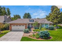 Charming ranch-style home featuring a brick facade, tile roof, and well-maintained landscaping at 10 Oakmont Ln, Littleton, CO 80127