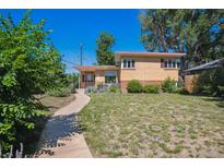 Charming brick home with a well-manicured lawn and inviting walkway, perfect for suburban living at 1497 S Garfield St, Denver, CO 80210