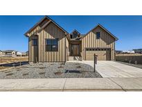 Charming exterior of a two story house with beautiful landscaping and an attached garage at 5134 Cupule Trl, Castle Rock, CO 80104