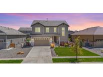 Beautiful two-story home featuring a well-manicured lawn, a two car garage, and lovely landscaping at 16268 Mount Silverheels Way, Broomfield, CO 80023