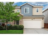 Inviting two-story home featuring a two-car garage, stone accents, and a well-manicured front lawn at 4025 Trail Stone Cir, Castle Rock, CO 80108