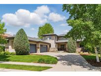 Stunning exterior showcasing a modern home with manicured lawn, mature trees, and a spacious driveway at 4405 Fairway Ln, Broomfield, CO 80023