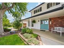 Inviting front porch with double doors, white bench, and landscaped flower bed at 841 Beech St, Golden, CO 80401