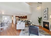 Bright and inviting living room features a cozy fireplace and open floor plan at 10550 W Jewell Ave # 301, Lakewood, CO 80232