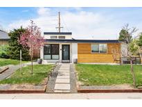 Charming modern home featuring a landscaped yard and a welcoming walkway, plus appealing wood and stucco accents at 401 S Ivy St, Denver, CO 80224