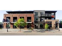 Contemporary mixed-use building featuring brick and metal accents, with retail spaces on the ground floor and residential above at 3420 W 32Nd Ave # 203, Denver, CO 80211