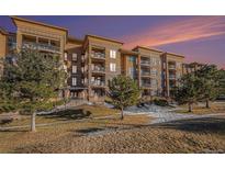 Attractive multi-unit building with landscaping and a sunset backdrop at 7865 Vallagio Ln # 308, Englewood, CO 80112