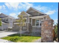 Charming single-Gathering home with a welcoming front porch, manicured lawn, and attached two-car garage at 21102 E Stanford Dr, Aurora, CO 80015