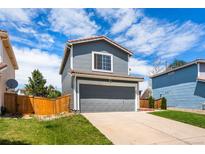 Charming two-story home features a gray exterior, red tile roof, and attached garage at 4184 Netherland St, Denver, CO 80249