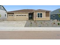 Charming single-Gathering home with a beige exterior, three car garage, and manicured front yard at 4716 Twelve Oaks Way, Castle Rock, CO 80104
