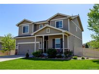 Charming two-story home with manicured lawn, covered porch, and attached garage at 11158 Carbondale St, Firestone, CO 80504
