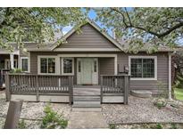 Charming home featuring a classic facade, inviting front porch, and flowering trees in a pleasant surrounding landscape at 6780 W 84Th Cir # 66, Arvada, CO 80003